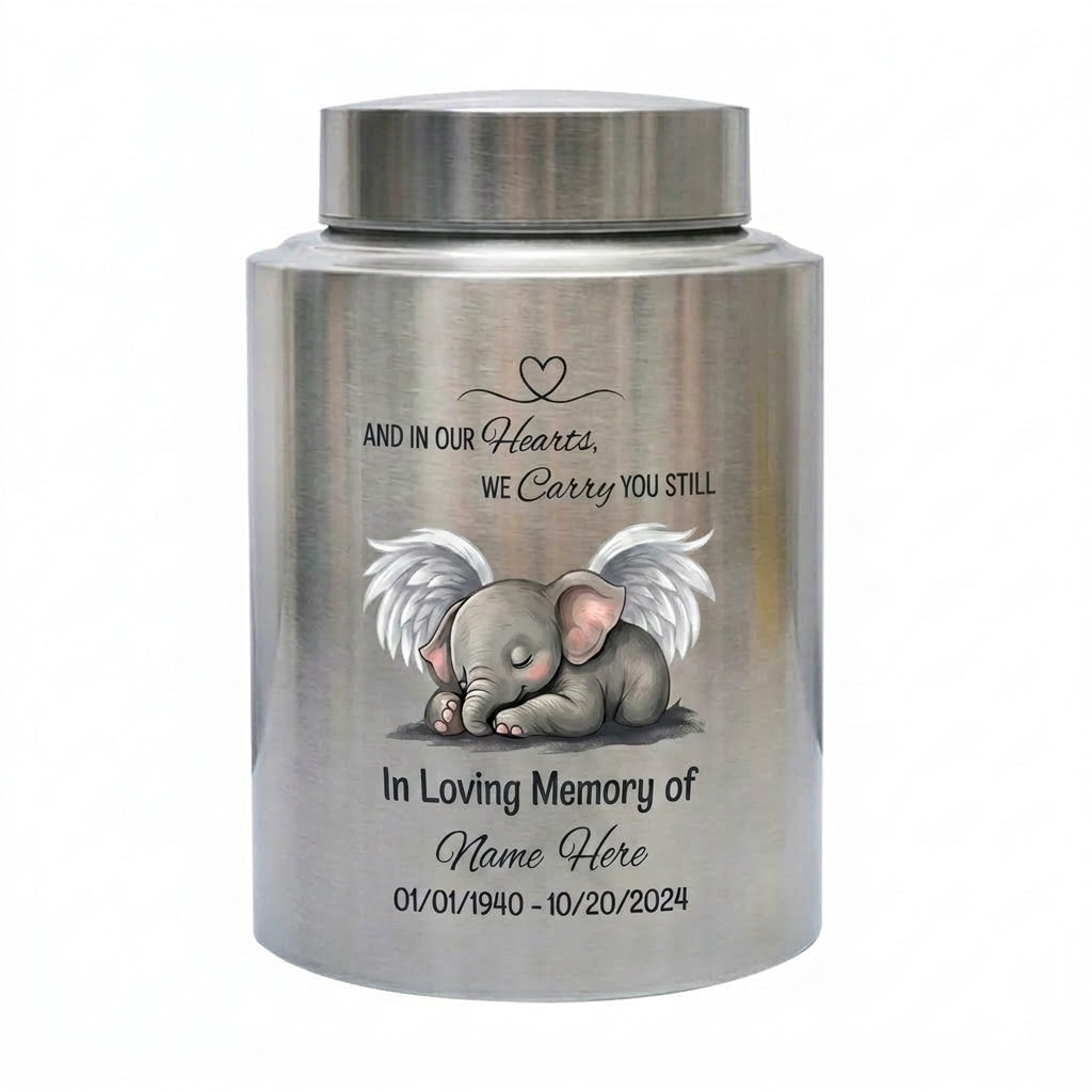 Personalized Baby Elephant Heart UV Printed Stainless Steel Infant Child Loss Bereavement And In Our Hearts We Carry You Still Quote Memorial Keepsake Urn, Memorial Gift, In Loving Memory - Image 1